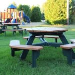 Empty picnic table in a park near a playground