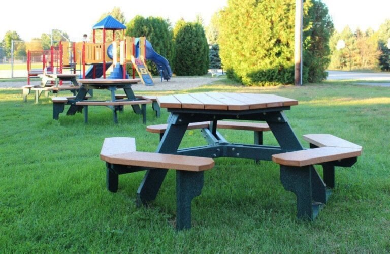 Empty picnic table in a park near a playground
