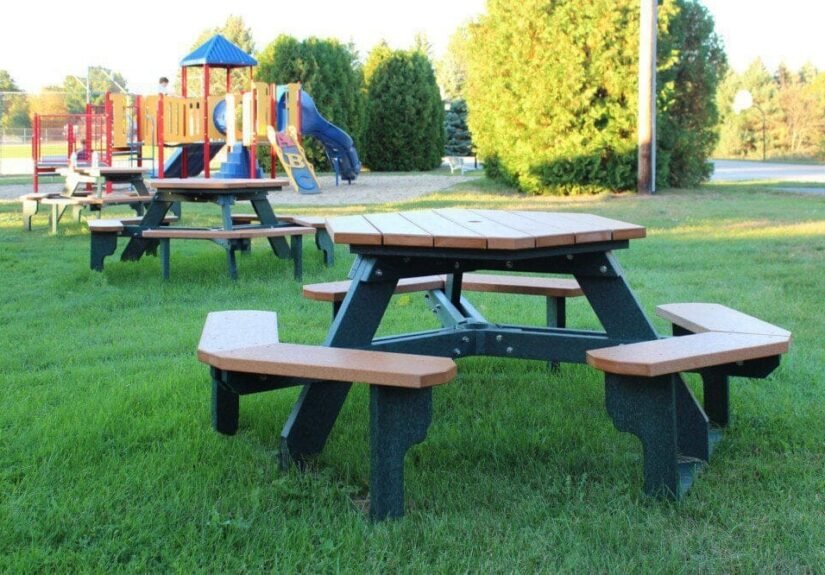 Empty picnic table in a park near a playground